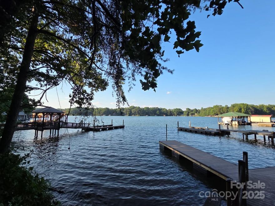 Charming waterfront Lake Norman lot with fantastic views. This lake lot has been recently dredged at the dock and cleared with mature beautiful hardwoods left in place. As soon as you arrive you will see fantastic water views from the entire lot. Rock shoreline where the waves subside. A private floating dock awaits you with PVC decking. A 4-bedroom septic permit is approved along with a survey and building soil report. Ready to start building your dream lake home today. Just 5 minutes away from Publix, Starbucks, Restaurants and all the new amenities in The Village Shoppes. Additional amenities projected within 1 mile. No HOA. Agent owner.