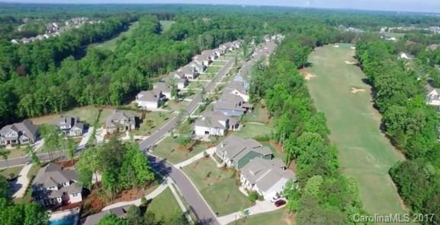 Luxury golf course home on 18th fairway in Springfield community of Ft Mill.  Immaculate condition and showered with natural light.  Beautiful hardwood floors, open floor plan, gourmet kitchen w/ tile backsplash, SS appliances, large island with seating.  Master bedroom on main along with three guest bedrooms and full-baths.   5th bedroom/bonus room with full-bath on 2nd floor.  Oversized screened porch overlooking tranquil fenced yard. A short walk to Anne Springs Greenway and Nature Preserve