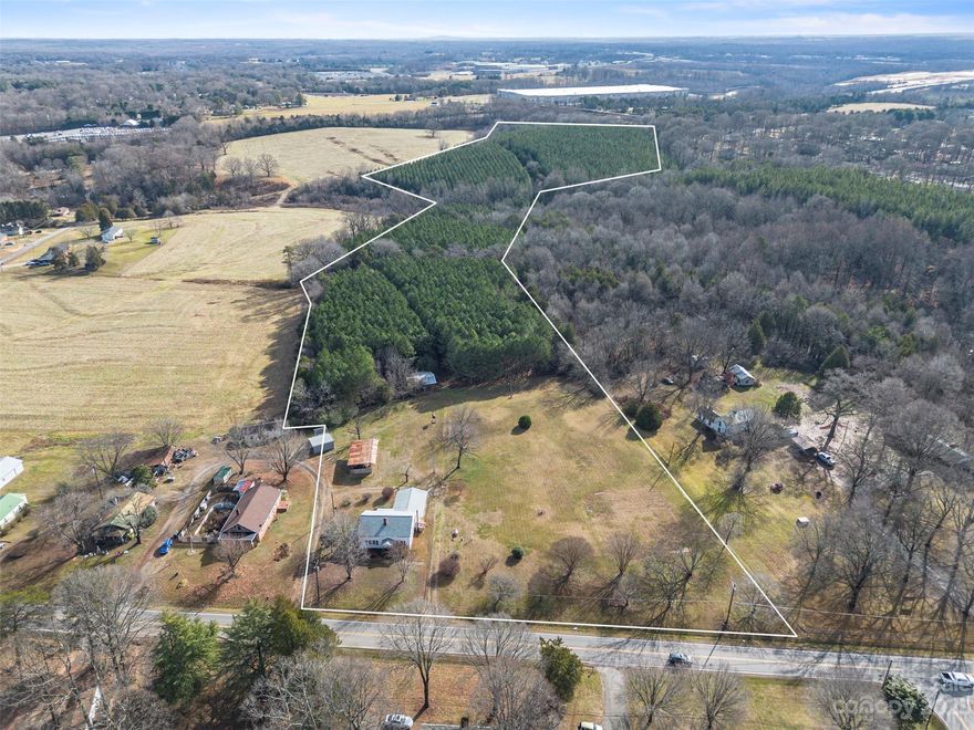 Amazing acreage primed for mixed-use development in Iredell-Statesville’s Jane Sowers North strategic gateway corridor. Gently rolling landscape with small, active stream near the center of property. Currently wooded, but timber does not convey. Turnersburg Hwy road frontage, close to future I-77 & Jane Sowers planned interchange, with additional platted right of way access from Jane Sowers on Robinhood Loop. Within 2 miles of Statesville’s prime retail, commercial and restaurant hub, and less than 10 minutes from I-77/I-40 Interchange. House, shed and barn all convey at no value. Personal property onsite does not convey and will be removed prior to closing. Property is co-brokered with Exp Commercial, LLC.
