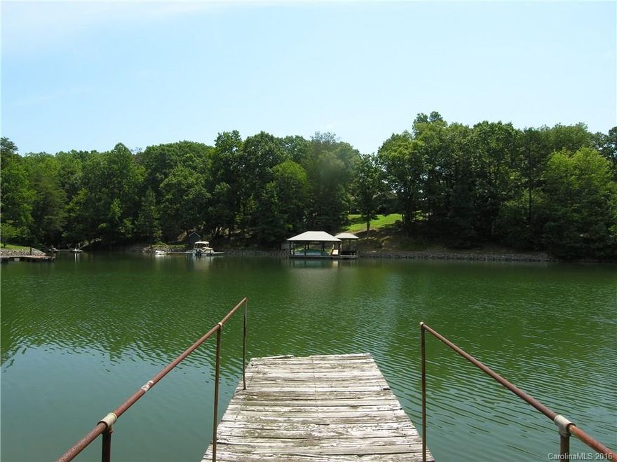 This lot will not last! .70 acre waterfront lot with 148' of shoreline in peaceful cove close to the main channel. Gently sloping lot is ideal for a basement. Rip rap and dock in place. Perfect location to build your dream home or use mobile home on property for a weekend getaway. Bring your own builder. No HOA. Great location, only 3 miles to 150/River Hwy and 5 miles to I-77. Walk to Stumpy Creek Park.