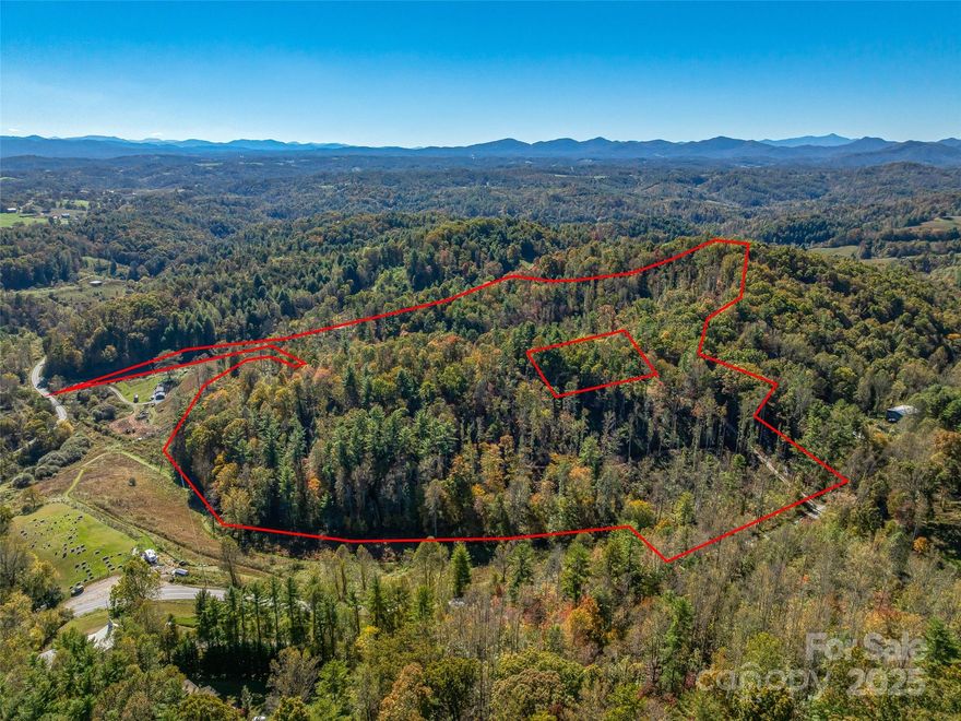 Welcome to 99999 Meadows Town Road in beautiful Marshall, North Carolina — a rare opportunity to own approximately 34 acres of stunning, buildable mountain land just minutes from downtown Marshall and within easy reach of Weaverville and Asheville. This property truly has it all: privacy, convenience, breathtaking long-range mountain view potential, multiple possible home sites, and the infrastructure to make your dream project a reality.
As you arrive, you’ll immediately appreciate the land’s gentle approach and the well-maintained road system that winds gracefully through the property, offering easy access to several prime build sites. Whether your vision is a private mountain estate, a multi-home family retreat, or a small residential development, this property offers a flexible and well-laid-out landscape to accommodate it all. The topography varies beautifully — from rolling meadows and open knolls to wooded ridgelines and shaded valleys — giving you endless possibilities for orientation, layout, and design.
Several locations on the property present opportunities for panoramic, long-range mountain views that stretch across Madison County and beyond. With selective clearing, you could create spectacular building sites that showcase the ever-changing colors of the Blue Ridge Mountains — stunning sunrises, glowing sunsets, and a tapestry of seasonal beauty that makes this region so special. Imagine relaxing on your future porch, overlooking the distant peaks while surrounded by the peace and privacy of your own mountain haven.
In addition to the acreage and build potential, the property includes a 3-stall garage/carport structure — perfect for immediate storage of vehicles, equipment, or recreational gear while you plan your build. This feature adds convenience and value for those looking to establish a workshop, hobby space, or temporary base during construction. The existing access roads throughout the property make exploration and development simple, connecting multiple potential building envelopes while preserving the site’s natural contours and privacy.
The combination of open land and wooded areas creates an ideal environment for those who appreciate both usability and natural beauty. There’s ample space for gardening, small-scale farming, or pasture, while mature trees provide shade, habitat, and a true sense of seclusion. With approximately 34 acres to work with, you can thoughtfully design a property that suits your lifestyle — whether that’s a mountain getaway, equestrian retreat, or collection of cabins for short-term rental opportunities.
Location is key, and this one strikes the perfect balance between rural tranquility and modern convenience. The property sits just a short drive to downtown Marshall, where you’ll find charming shops, cafés, and the scenic French Broad River. A quick 20-minute trip brings you to Weaverville’s restaurants and amenities, and Asheville is only about 30 minutes away — offering vibrant arts, dining, and entertainment options. You’ll enjoy easy access to everything Western North Carolina has to offer while coming home to your own private escape at the end of the day.
Whether you’re seeking an investment opportunity, planning your dream homestead, or simply looking for a peaceful place to put down roots, 99999 Meadows Town Road delivers exceptional potential in a truly beautiful setting. With its combination of long-range mountain view possibilities, existing infrastructure, versatile build sites, and proximity to some of the region’s most desirable mountain towns, this property represents one of the best opportunities currently available in Madison County.
Don’t miss your chance to own a piece of Western North Carolina’s mountain magic — 34 acres of endless possibility, ready for your vision.