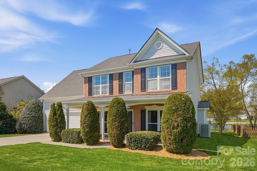 Wow—this stunning waterfront home with a rare double primary suite layout offers exceptional flexibility for multi-generational living and is nestled in one of the area’s most sought-after communities, known for its beautiful tree-lined streets and resort-style amenities.

From the moment you arrive, the home’s inviting curb appeal and expansive covered front porch—complete with ceiling fans—set the tone for comfort and charm. Inside, you’re welcomed by two versatile flex spaces at the front of the home, ideal for a home office, music room, reading lounge, or sitting area, perfectly positioned across from the formal dining room.

The spacious family room features a cozy fireplace and flows into the kitchen and breakfast area, creating an open layout perfect for both everyday living and entertaining. Large windows showcase breathtaking views of the backyard oasis, bringing in natural light and serene water views.

The main-level primary suite is generously sized and features a tray ceiling along with an updated en-suite bath, complete with a double vanity, large walk-in shower, and linen closet. Upstairs, a second primary suite with a private full bathroom provides an ideal setup for guests or extended family. You’ll also find two additional bedrooms and an oversized fifth bedroom or bonus room—perfect for a media room, playroom, or fitness space.

Step outside to your private backyard retreat, where an extended patio with a retractable awning invites you to relax or entertain while enjoying peaceful views of the pond and its elegant fountain—a truly rare and tranquil setting.

This exceptional community enhances your lifestyle with multiple stocked ponds, a community pool, park, and ball courts—all surrounded by picturesque scenery.

Conveniently located in Indian Trail in Union County, this home offers easy access to shopping, dining, and easy access to both the Monroe Bypass and I485, combining peaceful living with everyday convenience.