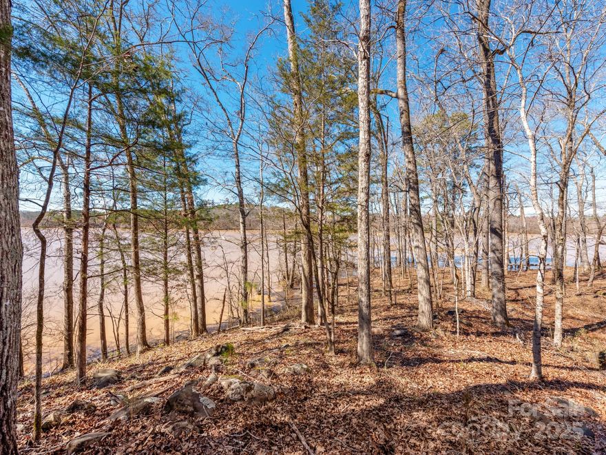 Excellent Opportunity to own a fully fenced in, cash-flowing hunting tract of land(or build home), w/ a 40x60 garage that has 2 rollup doors, buried electric to it, and was built in 2019! Discover the perfect blend of tranquility and adventure with this expansive almost 100-acre fenced waterfront property located on the serene Lake Wateree, nestled within Big Wateree Creek Cove. The property boasts an impressive 1,500 feet of shoreline and drivable outline. Conveniently close to I-77, this prime location offers both seclusion & easy connectivity. With 4,220 ft of paved road frontage, the personal retreat options are endless. The land features flat ridges adorned w cut pine & a rich variety of hardwoods, creating a stunning natural landscape. Upland oaks dominate the remaining acreage, offering a diverse ecosystem that supports a thriving population of deer, turkey, quail & waterfowl. Miles of trails are perfect for ATV/dirt bike adventures.