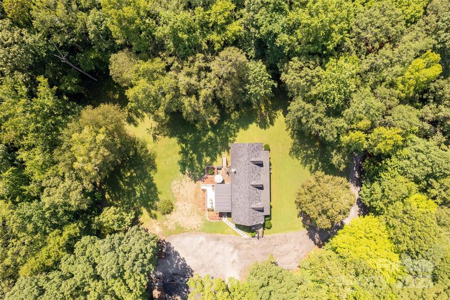 Location, location, location!  333 feet of road frontage on 521. Imagine the possibilities. Home in excellent condition. Open floor plan well taken care home in excellent condition with large covered porch and deck overlooking private wooded back yard. Shop has wiring and plumbing.