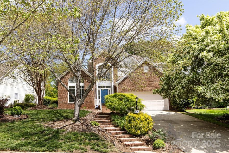 Tucked within sought-after Woods at Lake Davidson, this charming home offers rare access to Lake Davidson from a peaceful tree-lined neighborhood. Just 1/2 block from community pier, dock & boat slips, enjoy the best of lake life-kayaking at sunrise, peaceful strolls & the convenience of a walkable, vibrant setting. Main level features primary suite, open-concept layout perfect for entertaining & vaulted great room w/gas fireplace. Beautifully landscaped backyard complete w/pond feature, mature trees,& stacked-stone garden bed. Kitchen w/ large island &  custom live-edge walnut countertop sustainably sourced from local trees, blending natural beauty w/thoughtful craftsmanship. Upstairs has 2 additional bedrooms, full bath,&  small loft space. Freshly painted in warm neutral tones w/ new carpet on main level, this home is move-in ready. Walkable to Main St, Greenway & park. Quick access to I-77 & shops & dining at Exit 30, you'll love the blend of nature, community, & convenience!