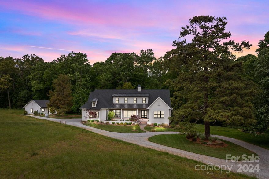 Modern architecture, on a unique, private and semi-rural homesite that is only a 6-minute drive from the center of Davidson.  This 2-acre property sits on conservation land encompassing 7 acres, including virgin
forest and a transitional meadow. The home offers all the luxury of modern design along with permanently protected private space and views in all directions.  The house and guest house were designed to take full advantage of the light in winter, shade in summer and situated within a grove of trees that was planted 150 years ago.   This feels like country living, but within striking distance of great restaurants and
Davidson college.

The guesthouse provides an opportunity for a multigenerational compound, or an incredible office.  This could be a wonderful hobby farm as the home sits back in the meadow.

Minutes to River Run Country Club, Davidson Equestrian Center and Historic Downtown Davidson with its restaurants, boutiques, farmers market and Davidson College.