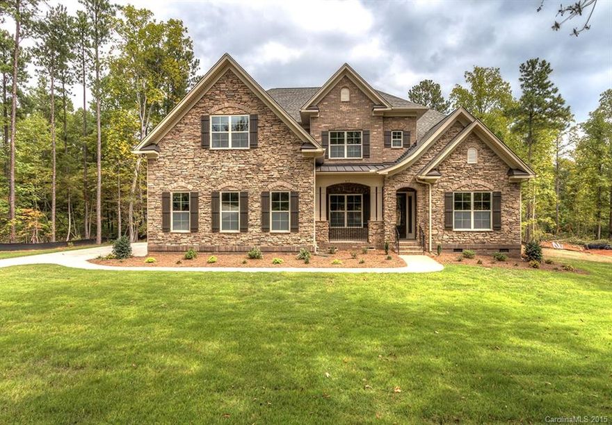 Owner's Suite on both main & 2nd fl. in this brick/stone executive home.Gourmet kitchen:painted cabinets,double ovens,island,granite,SST app,butler's pantry.Family Rm w/stone fireplace,coffered ceiling,access to screened porch.Hardwoods on main.Bonus rm up w/french doors.2nd Owner's Suite up has sitting room,2 walk-in closets.2 add'l bedrooms w/full baths.Energy efficient inc.tankless water heater.On over 2 acres in natural wooded setting in Lake Wylie,yet less than 10 min to Buster Boyd Bridge.