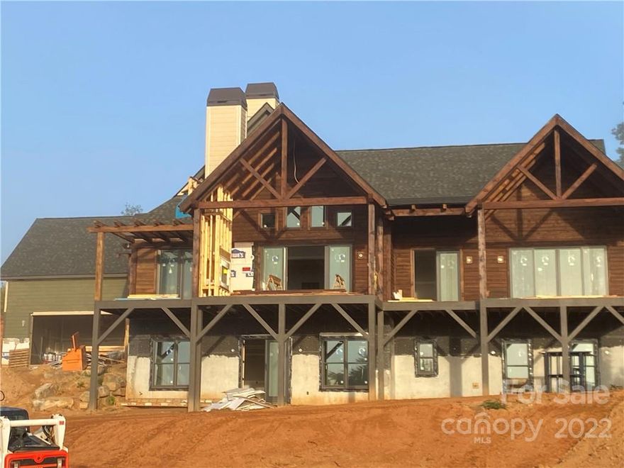 Rustic Mountain Modern Home Available Dec 2022. Stunning mountain home with spectacular, unrestricted, long range mountain views and beautiful sunrises. Timber frame entrance leads into an open floor plan with combined kitchen, dining room, vaulted great room, primary bedroom, guest suite and office on main floor.  Enjoy 800' feet of covered decks and a stone wood burning fireplace the perfect outdoor living space. Lower-level includes family room, bar area, guest suite, media/ gym room. Quality craftsmanship, design and finishes. Features include  pantry with built in cabinets, 8' stained doors, 5" Hickory Hardwood floors, Thermador appliances, private rear, and side yard. Extensive landscape plan to be completed with stone retaining walls, large trees, and lots of grassed area. Perfect location with easy access to Hwy 26, 15 minutes to Downtown Asheville, 5 minutes to grocery stores, restaurants, and shopping. Located 10 minutes to the quaint and popular Downtown Weaverville.