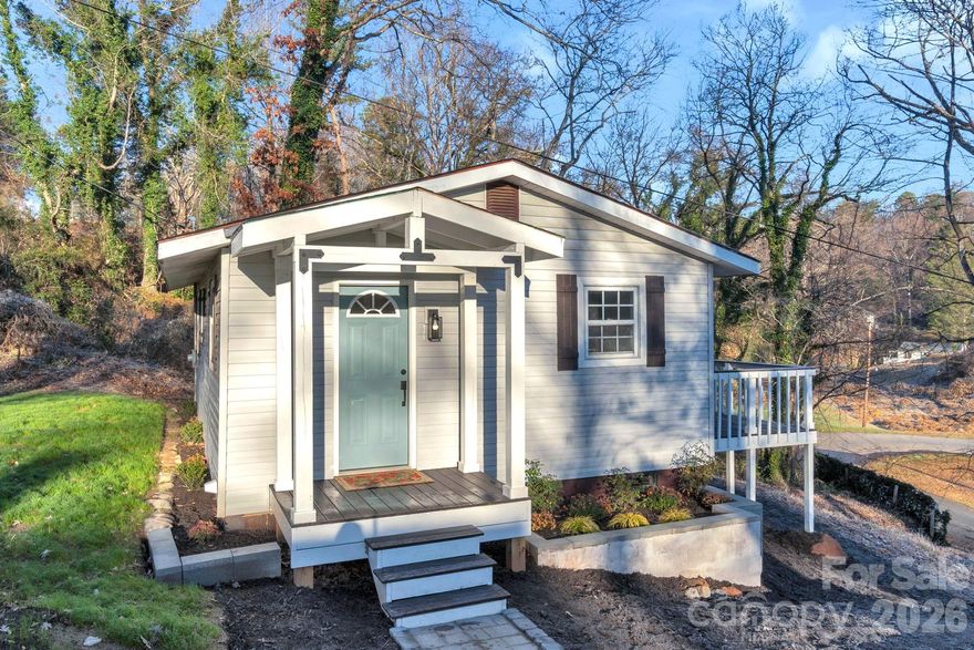 Experience the coveted advantage of living in an established neighborhood, situated perfectly within walking distance of the heart of downtown Tryon! Enjoy the convenience of strolling to town, where you'll find an array of dining options, shopping boutiques, art galleries, community events, and an upscale theatre that will make your lifestyle truly enjoyable. The home features a concrete driveway, LVP flooring throughout, wood-accented countertops, and a pass-through window with bar for easy entertaining. You'll find a bright and open layout featuring a tiled walk-in shower and bedrooms filled with natural light, offering ample closet space, making the home feel stylish and comfortable. Spend your mornings sipping coffee on the large back deck, watching the Cardinals flit between the trees while deer meander by. This property is the perfect balance between tranquility and convenience. Photos virtually staged.