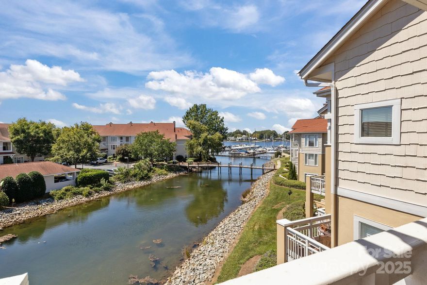 Experience lakefront living at its finest in this beautifully appointed waterfront condo on LKN.  Located in the heart of Cornelius, this residence offers stunning water views from an oversized balcony.  The open-concept floor plan features a bright and airy living area, high ceilings, with gas log fireplace, sliding door to balcony, built-in dry bar area with beverage center, beautifully updated kitchen with S/S appliances, granite countertops, tiled backsplash and under cabinet lighting. Spacious primary bedroom with large walk-in closet, large garden tub, and double sink vanity in primary bath.  Community amenities include waterfront pool area, sidewalk path along water edge, kayak storage, tennis court and lake access.  Nearby and within walking distance to dining and shopping at Birkdale Village.  Whether you're seeking a full-time residence or a weekend retreat, this property combines the best of convenience and lakeside lifestyle.