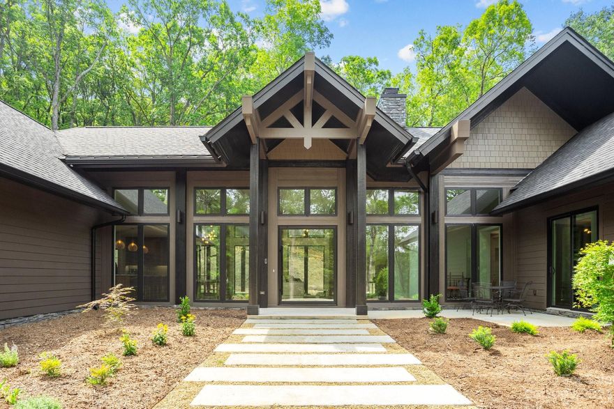 This custom built home is in a gated community with estate sized lots and stunning sunset views. Luxury finishes adorn every room, showcasing the meticulous attention to detail that went into crafting this masterpiece. Walnut cabinets, Ann Sacks tile backsplash, and quartzite counters create a sleek and modern aesthetic while providing a functional workspace for culinary enthusiasts. Pamper yourself in the primary bathroom with marble tile, enormous walk in shower with rainhead and soaking tub, and for the ultimate in luxury, immerse yourself in the sauna offering a rejuvenating escape from the stresses of everyday life. Community amenities including a pool, tennis, and boat ramp beckon with panoramic views of High Rock Lake and majestic mountains that frame the horizon. Whether you're seeking a tranquil retreat or an active lifestyle, this elegant mountain house offers the best of both worlds with serenity and seclusion close to Lexington and Salisbury. Priced below appraised value.