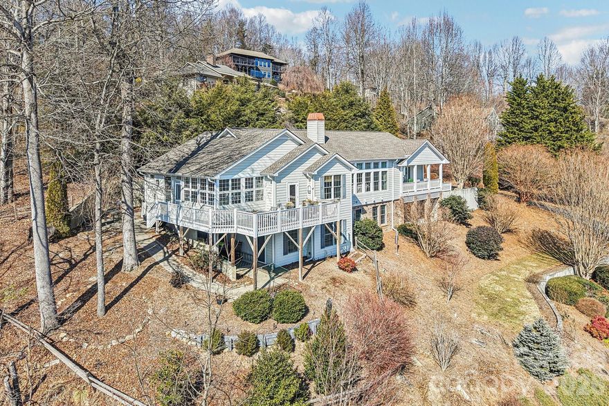 Breathtaking long-range mountain views set the tone for this beautifully maintained Laurel Park home — where comfort, thoughtful design, and effortless living come together.

The main level is designed for easy everyday living, featuring an expansive great room with soaring 11’ ceilings, gleaming wood floors, and a striking limestone fireplace. Natural light fills the space and flows seamlessly into the open dining area, updated kitchen with cherry cabinetry and solid surface countertops, and a welcoming keeping room ideal for casual gatherings.

One of the home’s most beloved spaces, the sunroom captures panoramic views year-round — the perfect setting for morning coffee or quiet evenings watching the mountains change with the seasons.

The primary suite is conveniently located on the main level and offers a peaceful retreat with a beautifully appointed bath and private office nook. A second main-level suite provides flexibility for guests or multi-generational living.

Downstairs, the lower level expands your living space with a generous media or hobby room and additional flexible areas — ideal for entertaining, creative pursuits, or extended stays. A second en-suite provides flexibility for guests or multi-generational living.

Recent updates reflect the care and attention this home has received over the years.

With true main-level living, expansive additional space below, and sweeping long-range views, this Laurel Park home offers both ease and elegance in a setting that feels miles away — yet minutes from everything.