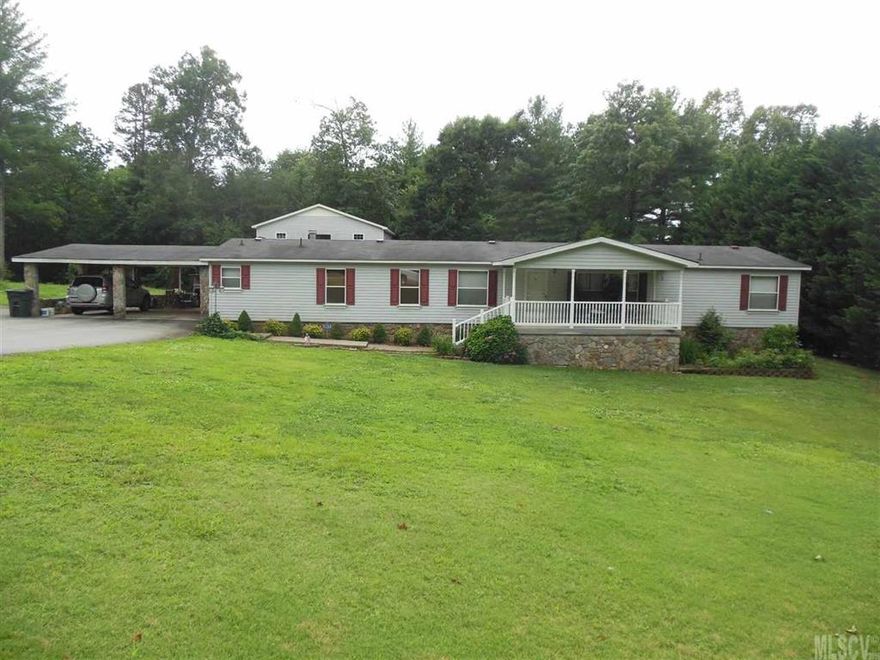 WELL MAINTAINED 4 BEDROOM, 2 BATH. 2 lots. Hardwoods & tile in living area, rock fireplace, front porch and double attached carport. 10x20 Detached garage with unfinished upstairs storage/bonus room. Home and lot are on two separate parcels...a total of 1.08 acres.