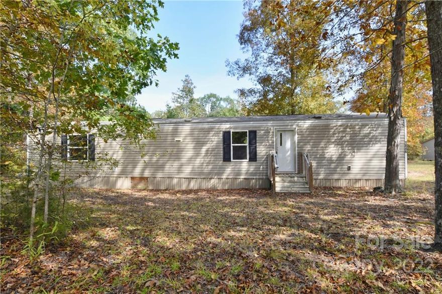 Like new singlewide on one beautiful acre and move in ready. Spacious great room, kitchen and eating area. 2 bedrooms and 2 full baths. Nearby Windy Hill and Blacks peaches, bush and vine. Flat backyard, wooded lot with extra privacy. Newer well 2019, septic is 20 years old. Previous mobile home was removed.