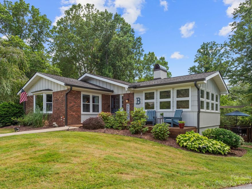 This move-in ready Heatherwood gem is too cute for words and seamlessly integrates indoor/ outdoor living with a screened-in porch, two levels of deck area for outdoor entertaining, and a level yard perfect for playtime and gardening.  On the main floor, a wood-burning fireplace in the dining area, and a "Florida" room full of natural light, a refurbished kitchen, featuring stainless appliances, custom wood countertops, and new floors throughout. A skylight brightens the hall bath, servicing two of the 3 bedrooms on the main floor and the primary bedroom has its own private ensuite bath. The finished basement offers a bonus room for guests, full bath with walk-in shower, laundry room, bar, and built-in storage. The two-car garage boasts a newly finished floor and storage shelving. The property borders HOA owned land which provides excellent winter views and direct access to the 5ac community park with French Broad River access. This highly desirable Heatherwood home has it ALL!