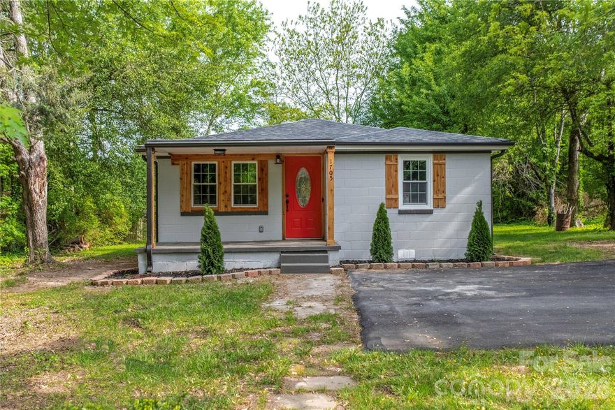 Positioned on a rare double lot, this thoughtfully renovated 3-bedroom, 2-bath ranch in Statesville delivers both modern updates and added outdoor space. Conveniently located near I-77, I-40, and Hwy 70, it offers easy access while maintaining a comfortable residential feel. The kitchen features wood-stained shaker cabinetry, granite countertops, stainless steel appliances, and an oversized gray subway tile backsplash for a clean, contemporary look. The bathroom is equally refined with a vessel sink vanity and a herringbone-tiled shower/tub combination. Additional upgrades include recessed lighting, replacement windows, and a covered front porch perfect for relaxing. With recent improvements to the roof, HVAC, insulation, drywall, flooring, water heater, and backyard fencing, this home is well-prepared for its next owner.