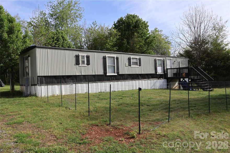 Enjoy a rural setting yet close to Statesville, Mocksville and I77 for easy commutes. This home has been fitted recently with new mini-splits throughout, a new underbelly with new insulation and vapor barrier, new plumbing in the majority of the house, recent septic inspection and pumping, New LVP, New interior paint, new back door, and recent improvements to the electrical box. There is a large shed measuring 20.3 X 11.5 that can have power ran to it, a large garden and firepit as well as fencing around the 0.77 acre yard. The third bedroom has been converted into a large pantry but can be returned to its original use as a bedroom. This quiet setting and home are ready for you. Ask about recent home inspection, pest and radon that can be available to you upon request.