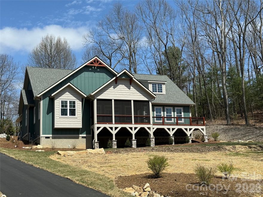 Rare, one-level new construction home offered atop Kenmure at nearly 3,000 feet elevation. Craftsman styled home with 2,588 square feet all on one level. This home is under construction and should be ready for occupancy on or around 04/15/2026 ...  Features open floorplan consisting of 3 Bedrooms / 2.5 Baths. The custom built kitchen will be equipped with GE stainless steel appliances, granite countertops, and plenty of storage. Also on the main floor you'll find the luxurious master suite, complete with a walk-in closet and a spa-like ensuite bathroom with a walk-in tiled shower + dual vanity sinks. Additional features include a Large 2-car garage + a spacious covered screened porch for a great place to relax and enjoy the beautiful mountain views. Stone fireplace in the great room and site - finished wood floors throughout the home. Welcome to your dream home in Flat Rock.  50% off Kenmure Membership Initiation Fee!