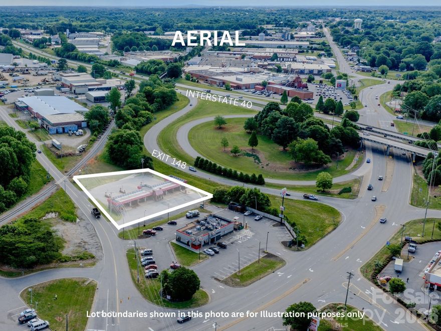 High-visibility commercial opportunity in the West Iredell corridor located at Interstate 40 Exit 148, with direct access to Hwy 64/90 and Northside Drive. This location offers strong traffic counts, excellent frontage, and immediate proximity to national retailers, fuel stations, and service-oriented businesses.
The property currently includes a functioning car wash facility featuring 7 self-serve bays, 1 touch-free automatic (LaserWash), and 6 vacuum stations, providing immediate income potential for an owner-operator or investor.

Positioned on a highly visible corner with multiple access points, the site also presents a compelling redevelopment opportunity. Surrounded by established commercial activity and interstate-driven traffic, this corridor continues to see consistent demand for retail, fuel, and service uses.

A portion of the rear of the property lies within a railroad right-of-way.

Ideal for investors, owner-users, or developers seeking a strategic, high-exposure site with both in-place utility and long-term upside.
