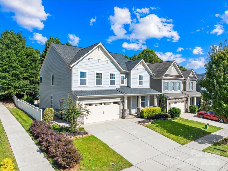 Welcome to Byers Creek, where comfort, convenience, and community come together in this beautifully designed 5-bedroom, 3-bath home with nearly 3,200 square feet of thoughtfully planned living space plus a ready-to-finish third floor.

From the moment you arrive, you’ll notice the charming curb appeal with its covered front porch—a perfect spot for rocking chairs and quiet evenings. Inside, the foyer opens to a formal dining room accented by elegant arches, upgraded lighting, and a coffered ceiling. The spacious great room features gleaming hardwoods, a cozy gas-log fireplace, and abundant natural light.

The heart of the home is the gourmet kitchen, boasting granite countertops, subway tile backsplash, a 5-burner gas cooktop with pot filler, double wall ovens, an oversized island with seating, and stylish pendant lighting. The butler’s pantry sits across from a walk-in pantry, making entertaining effortless. A bright breakfast nook overlooks the fenced backyard, while a convenient drop zone off the garage keeps daily life organized.

On the main level, you’ll find a guest bedroom and a full bath, ideal for visitors or a home office. Upstairs, the primary suite is a retreat with a coffered ceiling, two walk-in closets, and a spa-like bath featuring dual vanities, an oversized soaking tub, and a separate tiled shower. Three additional bedrooms, a full bath with double vanity, a large laundry room, and a versatile bonus/den space complete the upper floor. Stairs lead to a third-floor walk-up attic, offering expansion potential or exceptional storage.

Outside, the backyard is fully fenced with plenty of room for play and relaxation. Community amenities include a pool and playground, all just a short walk or golf cart ride away.

What truly sets this home apart is its unbeatable location. Nestled between Lakeshore Elementary, Lakeshore Middle, and Lake Norman High School, families will love the convenience of the private walking path directly to the schools. Byers Village—with Harris Teeter, restaurants, shops, and everyday conveniences—is just minutes away. For outdoor enthusiasts, Lake Norman State Park and Stumpy Creek Park are nearby, offering hiking, kayaking, and sports fields. Major retailers such as Target, Lowe’s, Sam’s Club, and HomeGoods are a quick drive, keeping errands simple.

Beyond its location, Byers Creek is known for its vibrant, tight-knit community. Residents enjoy neighborhood gatherings, food trucks by the pool, seasonal events like Easter egg hunts, and even a Halloween festival. In December, Santa himself makes a stop to visit with families.

This home is more than a place to live—it’s a place to build lasting memories. With its spacious floor plan, modern upgrades, and welcoming community, 183 Rustling Waters Drive is ready to be your next chapter.