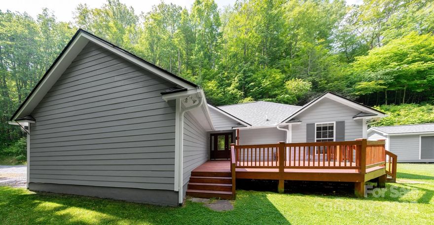 Set in a serene, private mountain setting, this impeccably cared-for home combines comfort, charm, and convenience. Warm hardwood floors flow throughout, while a gas log fireplace adds inviting ambiance to the living area. The primary suite features a walk-in closet and an ensuite bathroom with dual vanities. Thoughtful updates provide peace of mind, including a new roof and freshly painted exterior in 2024, a new water heater and septic service the same year, and a conditioned crawl space with dehumidifier added in 2025.  Step outside to a generous front porch that overlooks a bright, level lot—perfect for relaxing, gardening, or enjoying the surrounding natural beauty. A storage shed offers additional space for tools or outdoor equipment. Located just 25 minutes from Asheville, 10 minutes from Mars Hill, and only a short drive to Hatley Pointe Resort, this mountain gem is ideally positioned for year-round enjoyment.