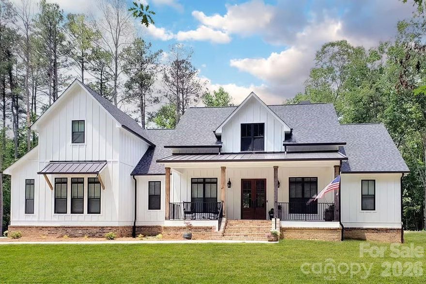 Modern farmhouse on nearly an acre in Kannapolis, custom level finishes that go far beyond typical builder grade. This home offers an open main level with a spacious great room, dedicated dining area, and a large kitchen with island, walk-in pantry, and direct views to the rear porch and backyard. The main-floor primary suite features a generous bedroom, dual-sink vanity, tiled walk-in shower, soaking tub, and walk-in closet for true retreat living.

Also on the first level you’ll find three additional bedrooms, a full bath, and stairs to a  flexible loft/bonus space perfect for a second living area, office, or playroom. Architectural details include covered front and rear porches, farmhouse-inspired exterior elevations, and thoughtfully placed windows for natural light throughout. Enjoy the feel of a private, country setting while still being convenient to Kannapolis, I-85, local schools, and area shopping and dining. No HOA means you can enjoy your large homesite with more freedom to personalize outdoor living, add a fire pit, garden, or play area. This is a turn-key new construction home; foundation, framing, and systems are designed to current code standards, and all square footages are approximate per the builder’s plans. Photos, finishes, and fixtures shown in marketing may reflect a similar build; final selections and colors to be confirmed with builder or listing agent.

Home will be completed by end of June!