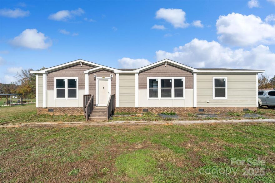 Welcome to this 2018 manufactured double-wide home nestled on nearly an acre of level, picturesque land in the peaceful countryside. This updated 3-bedroom, 2-bathroom home seamlessly blends modern touches with rustic charm. The heart of the home, the kitchen, has been beautifully transformed with stunning new cabinets, sleek granite countertops, and a stylish tile backsplash—perfect for entertaining or simply enjoying a quiet morning. The spacious primary bedroom offers a private oasis, featuring a luxurious en-suite with double vanity sinks topped with granite, a freestanding soaking tub, and a separate tile shower. Two additional bedrooms provide flexibility for guests, a home office, or a growing family. Outside, the expansive, level lot provides endless possibilities—whether you dream of gardening, setting up a play area, or simply enjoying the serene views of the countryside. Schedule your showing today!