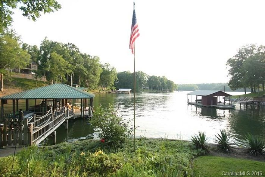 IDEAL LAKE COTTAGE! High quality construction Cedar plus Brick A-frame home on LKN! Hardwoods, vaulted GR, 2 fireplaces, updated Kit w/ granite, Master on main, 2nd BR upstairs & lower level Rec Room. Wrap around 50% Trex Deck, 2-Car Carport, Tree House, Storage Bldg, large Covered Patio w/ fans, Dock w/ Covered Pier,  2 Boatslips, 2 Boat lifts & 2 Jet Ski lifts. .789 of an acre w/ a gentle slope off Hicks Creek w/ great lake views of 2 coves & LKN State Park! Dead end street w/ only 8 homes!