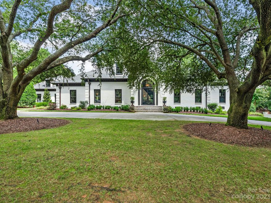 Beautifully updated painted brick home located in the gated community of Seven Eagles, adjacent to Quail Hollow Club. 24 hour security, private lot with .77 acres and circular drive. Ten foot ceilings, grand foyer, and incredible molding, wainscoting, judges paneling & coffered ceilings throughout. The primary, located on the main floor, is exquisite. Large walk-in closet, 2 water closets with heated Toto seats. Guest BR is currently being used as a gym, has ensuite bath. The study has custom bookshelves and could be used as additional bedroom. Large den/family room has a beautifully designed wet bar, floor to ceiling glass wine display and gas fireplace. Kitchen has an abundance of cabinetry & high end appliances, quartz countertops and eat-in breakfast room. The bonus room has a separate staircase, wet bar & built in bookshelves. Large walk in closets throughout. 2 walk in storage areas, 3 car garage, copper gutters.