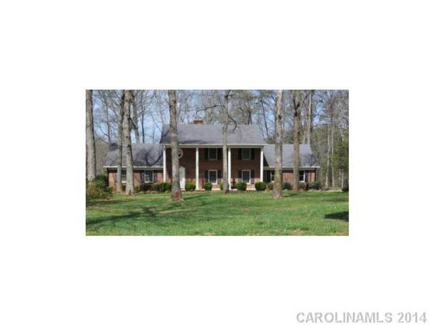 Stately 4BR/2BA + 2 half baths in over 3500 HSF w/formal & informal areas. Each & every room is large. KIT/Den has gas FP w/new counter tops & tons of cabinets & built-in desk & brick flooring. Huge & versatile laundry room. Hardwoods throughout except loft & Sun room that overlooks back w/100's of azaleas & mature landscaping. Great working barn on 5 acres. Freshly painted throughout.