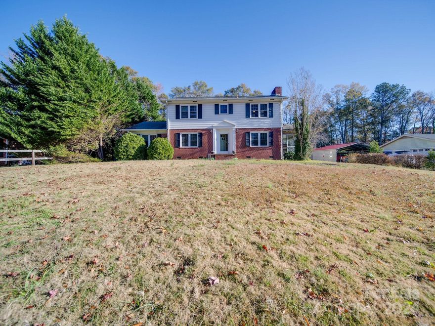 Nestled in the serene well-established Rice Woods Subdivision, this spacious 5-bedroom, 2.5-bath home offers an ideal setting for a large family. Set on a generous 0.44-acre lot, the property boasts a stunning stamped concrete patio, perfect for outdoor gatherings and entertaining. Inside, the home features beautiful hardwood floors and a functional layout. The master bedroom, located on the main level, includes a full bath for added convenience. The main floor also offers a formal dining room, a sunlit and inviting sunroom ideal for morning coffee or a relaxing read, and two comfortable living areas—one complete with a cozy wood-burning fireplace. Upstairs, you’ll find four additional bedrooms and 1.5 baths, providing plenty of space for family or guests. Outside, a separate storage building adds practicality, while the expansive backyard invites play and relaxation. This home combines comfort, space, and charm in a peaceful neighborhood setting, ready to welcome its next owners.