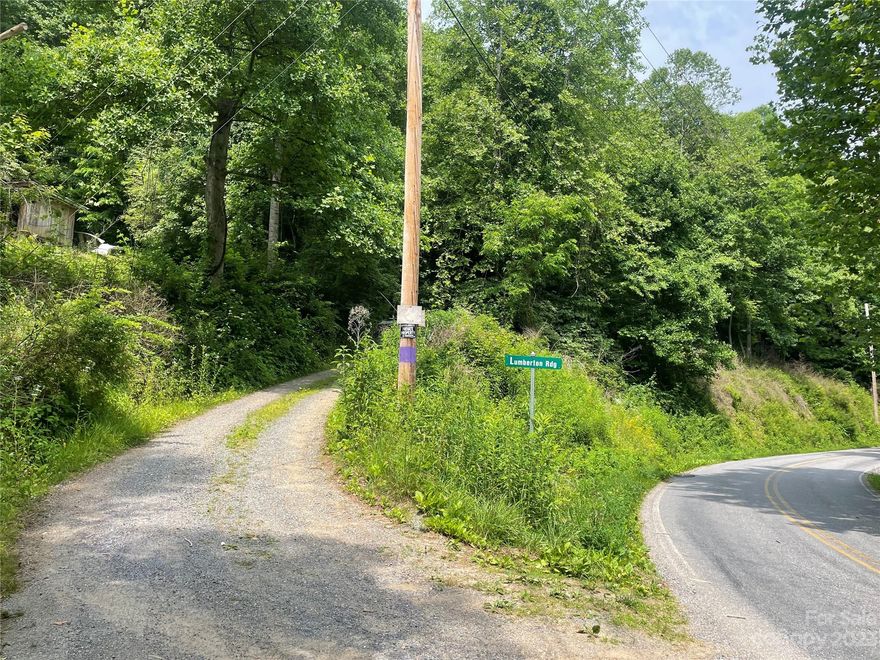 REDUCED MOTIVATED SELLER! Great lot with NO RESTRICTIONS and NO HOA, easy access, private and in a great location! Close to I-40 for a quick commute to Asheville. Located across the street from Jonathan Creek river.  Lot starts at White Oak Rd when you take a left turn on Lumberton Ridge road which wraps around most of the lot.The top of the property has a potential for some great views with some trimming and grading. Along the top edge is a wider tier of gently sloping land which would likely be the best location to build a house with some nice views.