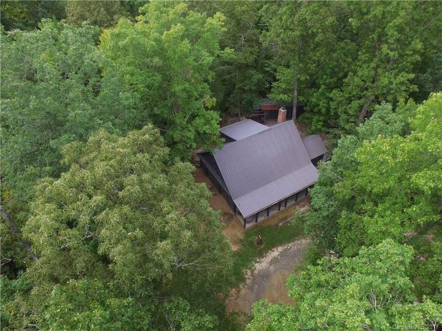 Sporting-Recreation-Hunting-Shooting Range-Farmhouse & Timber Land with something for everyone! Superior craftsmanship. Charming cabin has rocking chair front porch. Kitchen double French doors opens to side porch for evenings watching the sunset. Great room with beams, stone fireplace & wood burning stove. Master bed down. Upper level has huge office/bonus room & second bedroom. NEW generators & water well system. Greenfields, pastures, shooting range and Turkey Creek borders back of property.