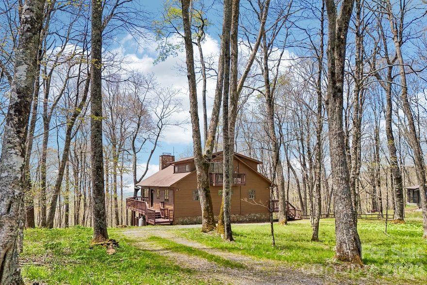 ONE OF THE BEST LOCATIONS IN THE RESORT!! High elevation over 4500ft and amazing long-range views right off paved road, across from National Forest on almost flat lot/driveway on cul-de-sac. This spacious contemporary home on 1.30 acre offers many updates. Roof is 5 years old, flooring in lower level, window tinting, garage refrigerator, pool table, 2 whole home dehumidifiers, 2 new mini splits, exterior pressure washed and stained as of (04/20/2026), some newer furnishings, new refrigerator in kitchen and tree work. This home is fully furnished except for a few pieces of artwork and personal effects. Nice open floor plan w/cathedral wood ceilings and lots of glass to take in the views. Primary bedroom on upper-level w/private bath and private balcony. Main level w/great room/ dining area, 2 bedrooms and full bath, spacious kitchen w/walk in pantry. Lower level with family room/wet bar, one-bedroom, full bath and bonus room for storage. Mud room area and one car garage in lower level. Great yard for pets, kids or fire pit. Large double deck for entertaining with plenty of parking in flat circular driveway. Community water system maintained by Carolina Water. Optional Village Club Membership. Current survey attached. MUST SEE THIS VERY SPECIAL WELL-MAINTAINED HOME IN GATED COMMUNITY WITH MANY ACTIVITIES AND HATLEY POINTE BOUTIQUE SKI SLOPES, MTN BIKING AND RESTAURANT OPEN YEAR ROUND.
