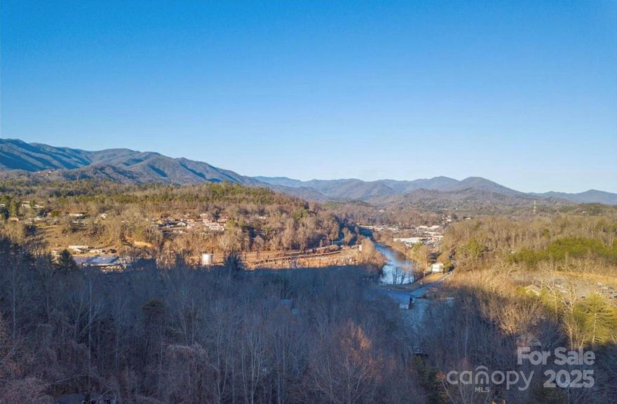 .25 acres near downtown Bryson City with city water and sewer. Limited restrictions: no livestock, no metal siding or roofing. Dirt road access, off paved public road.