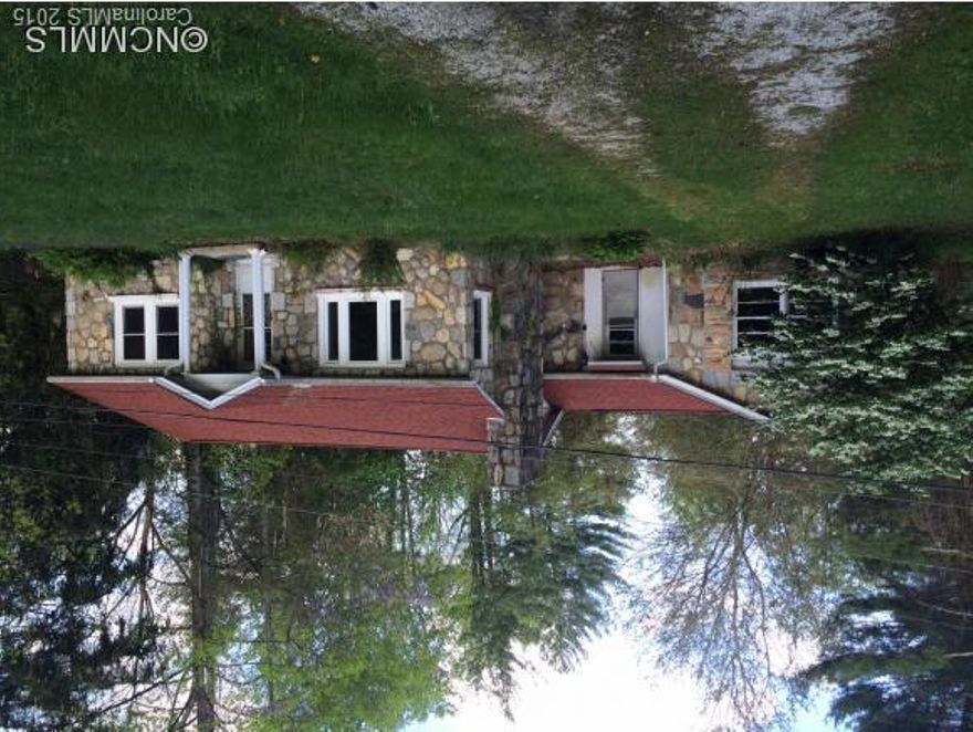 Conveniently located one-story 2BR,1BA "classic rock" home on .64 level acres.  New roof and windows in 2014. Hardwood floors. Large backyard with creek.