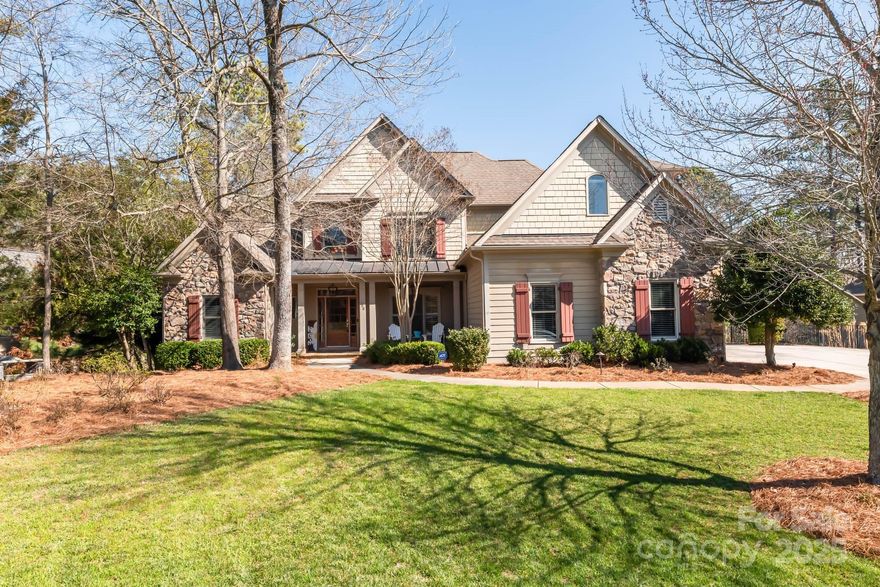 This gorgeous custom built home is in Heron Cove on Lake Wylie. The home features four large bedrooms plus a bonus/bed room, large office with custom built in desk. Primary suite on the main level with custom built walk in closet. Upgraded Oak flooring throughout. Custom kitchen featuring granite countertops, beautiful wood cabinets, and gas cook top with down draft vent. All open to the great room with nearly 20ft ceilings floor to ceiling stone fireplace and custom built-ins. Finished basement walk out to paver patio, bedroom with on suite. 500 sq/ft of unfinished basement storage. Also, large open area for home theater, table games, bar/kitchenette for entertaining. Screened porch, elevated deck with pergola overlooking private, wooded, meticulously cared fenced in lot. Rare near lake lot with flat grass backyard. Large 3-car side load garage. Amenities- Pool, playground, boat/RV storage lot. Kayak/paddle board launch area. Boat launches just outside the neighborhood.