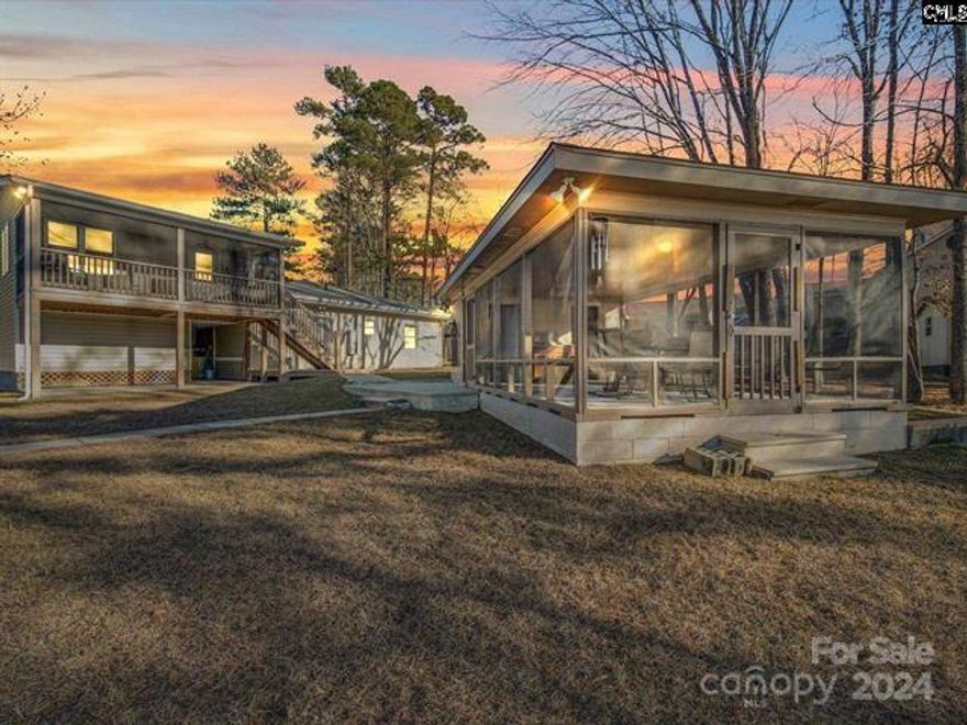 Lakefront Haven! Welcome to 1266 Miller Road on Lake Wateree in Camden, a picturesque lakefront property offering a blend of tranquility and lake living. Nestled in a large protected cove with 309 feet of water frontage, this 4-bedroom, 2-bath home is a rare gem. The heart of this retreat is the primary suite upstairs, featuring a private screened porch that invites you to unwind with stunning lake views. The primary suite has a two vanities and two large closets. The interior boasts a spacious living room, centered around a large fireplace, perfect for cozy evenings. The covered 14x28 outside screened-in patio (with a sink & electric) extends your living space outdoors, ideal for entertaining or quiet reflection. A double bay floating dock and boat ramp grants easy access to deep waters, enhancing your lakeside experience. Located just 8 minutes from Camden, this property offers both seclusion and convenience, making it perfect as a weekend escape or a full-time residence.
