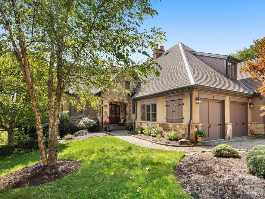 Located within The Meadow, one of the most popular and sought-after enclaves in the prestigious Cliffs at Walnut Cove, this exceptional residence offers a rare combination of high-altitude privacy and premier community amenities. Residents enjoy access to a world-class lifestyle centered around an 18,000-square-foot wellness center, indoor and outdoor pools, tennis courts, and a luxury spa. The community’s crown jewel is a Jack Nicklaus Signature golf course, complemented by an award-winning clubhouse and "The Tavern" for fine dining. Bordering the Pisgah National Forest and located just minutes from the Blue Ridge Parkway and Asheville, this large townhouse was meticulously renovated "down to the studs" in 2021. The home is designed to capture warm morning light through spacious windows, offering serene views of mountain vistas and the soothing sounds of a stream and waterfall in the south-facing backyard.The sophisticated floor plan is engineered for effortless entertaining, highlighted by a vaulted great room exceeding 20 feet with a beamed ceiling and an integrated sound system that flows throughout the home. The main level features a gourmet chef’s kitchen equipped with professional-grade Bosch, Wolf, and SubZero appliances, alongside a convenient powder room and laundry suite. The master wing, also located on the main floor, serves as a private sanctuary with a spa-like ensuite featuring Italian honed marble, Brizo fixtures, and custom cabinetry. This master bath includes a frameless shower, Italian porcelain tile, a Victoria & Albert soaking tub, and two custom his-and-her walk-in closets.  The lower level offers an expansive secondary living area, including two generous guest suites and a living room prewired for media with a custom surround sound system. This level is further enhanced by a wet bar featuring a 7-foot SubZero wine refrigerator, making it an ideal space for hosting guests. With over 3,300 square feet of heated living area, the home also provides ample outdoor living space, including a covered patio, a porch, and a deck for enjoying the mountain air. While the hot tub does not convey, a Cliffs membership is available to the buyer, providing full access to the elite amenities of Walnut Cove. This property represents a unique opportunity to own a fully modernized luxury retreat in Arden's premier gated community!