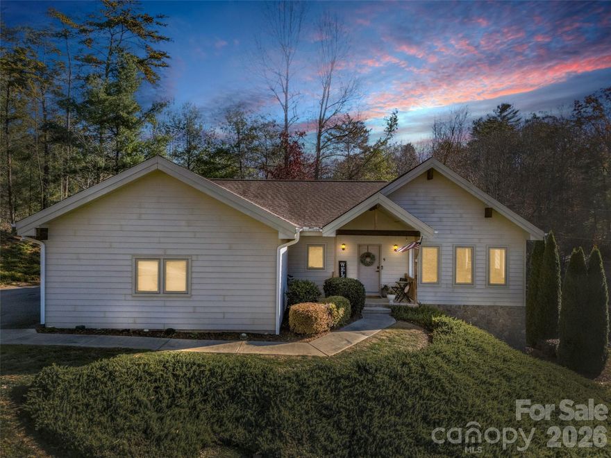 This sophisticated retreat in Fairway View Estates offers an elevated lifestyle, perfectly positioned alongside Reems Creek Golf Course. Combining architectural character with updates, this home is a masterclass in light and space. Well built, open living space, The great room and dining area feature soaring vaulted ceilings with exposed beams, creating an airy, open-concept environment bathed in natural light. Enjoy morning coffee on the screened porch or host sunset gatherings on the sprawling deck, both seamless extensions of the living space. Kitchen updated in 2023 with new stainless appliances, granite countertops and tile backsplash. Generous primary ensuite on main level, all solid wood doors on main level. The walk-out lower level is exceptionally bright, featuring large windows, two additional bedrooms, and a cozy family room with a wet bar. Double doors lead directly to a private patio. A massive storage/mechanical room provides the perfect canvas for a home gym, workshop, or hobby space. Enjoy the peace of a private community while remaining just minutes from the charm of downtown Weaverville and the world-class dining of Asheville. See Reems Creek Golf Club website for info about becoming a member to enjoy the 18-hole golf course, outdoor pool, clubhouse, pickle ball court, grill & bar and year-round activities. VA Assumable 2.5% loan for qualified buyer!