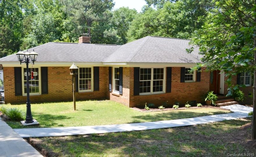 Gorgeous all brick home tucked away on a 1A. wooded lot with county only taxes. Custom built one owner w 2580 sq ft. Gourmet kit. with Dbl. oven, down/draft stove, raised panel oak cabinets w/ under cabinet lighting, jenn-air stove, pull outs, new Bosch DW, pantry. Wood FP in den. Basement level rec. room with unlimited uses. New roof, windows, HVAC Cleanair effects. The brick finished outbuilding is fabulous with it's own HVAC, ceiling fans, coated  floor.600 sq. ft. crafts, music studio?  USDA