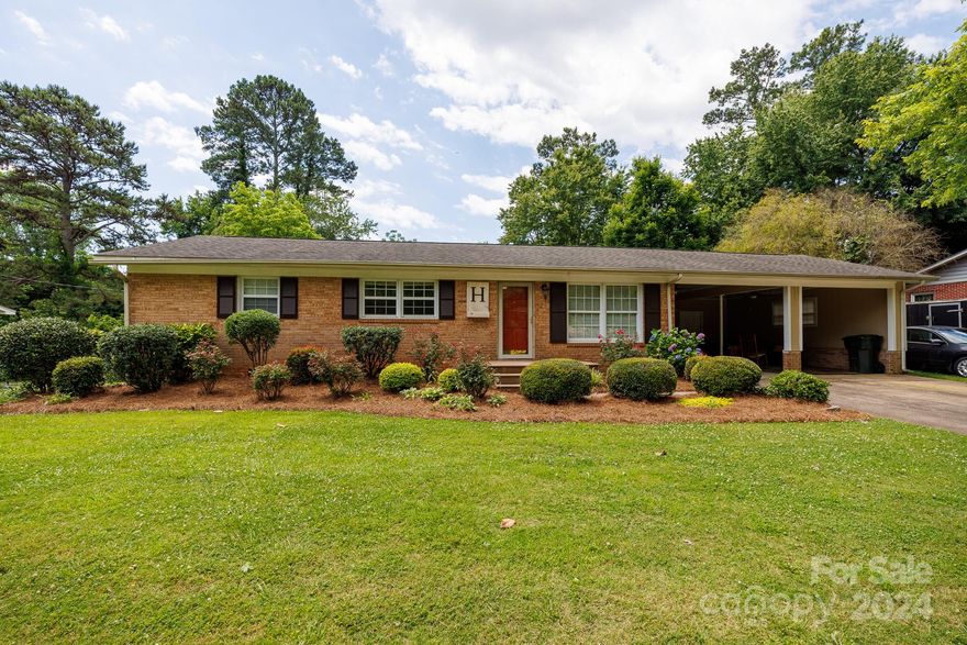 Don't pass this one by!  A lovely landscaped yard showcases off this home from first view.  Inside you'll find beautiful kitchen cabinets with granite counter tops, eat in area and hardwoods.  Great room with gas log fireplace and built in bookshelves.  Large deck and a patio with pergola, detached garage in back and a 2 car attached carport.  Sold as is.