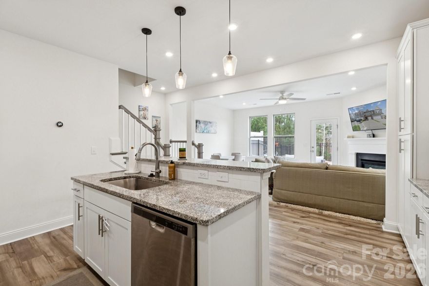 Welcome to this highly desirable Masons Bend townhome, offering exceptional amenities, natural surroundings, and a convenient Fort Mill location. This 3-bedroom, 2.5-bath townhome with a one-car garage combines modern finishes with low-maintenance living (lawn care included in HOA fee) in one of the area’s most sought-after communities. The first floor features durable vinyl plank flooring, an open-concept layout, and a bright white kitchen with quartz countertops, gas cooktop, ample cabinetry, and a designated dining area. The living room includes a gas fireplace and opens to a fenced backyard with patio, backing to a natural area—perfect for relaxing or entertaining. Upstairs, the oversized primary suite is privately situated at the back of the home and includes a large walk-in closet and en-suite bath with dual vanities and walk-in shower. Two additional bedrooms are located at the front of the home, along with a full bath featuring dual sinks and a tub/shower combo. Convenient laundry hookups are also located on the second floor. Masons Bend is known for its resort-style amenities, including a fitness center, outdoor pool, picnic areas, playgrounds, sidewalks, street lights, golf-cart-friendly streets, and direct access to the Catawba River with kayak/canoe launch, as well as the Carolina Thread Trail for hiking and biking. Ideally located close to dining and shopping, just 1.5 miles from I-77, and under 30 minutes to Uptown Charlotte and the airport, this home offers the perfect blend of lifestyle, convenience, and community.