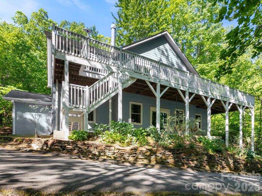 Move-in ready mountain cottage with privacy, forest views, and inviting indoor-outdoor living. A newly refinished wraparound deck and lower-level swings set the tone for relaxed mountain living.

Inside, cathedral ceilings and an open layout highlight granite countertops, a breakfast bar, spacious dining area, and a wood-burning fireplace. The main living area opens directly to the expansive deck—perfect for entertaining or unwinding.

The finished basement adds a large second living space, full bath, and two flexible bonus rooms, with sliding doors framing the natural surroundings.

Circular driveway, designated parking, and acreage with trail potential complete this versatile property—ideal as a primary home, second home, or investment.