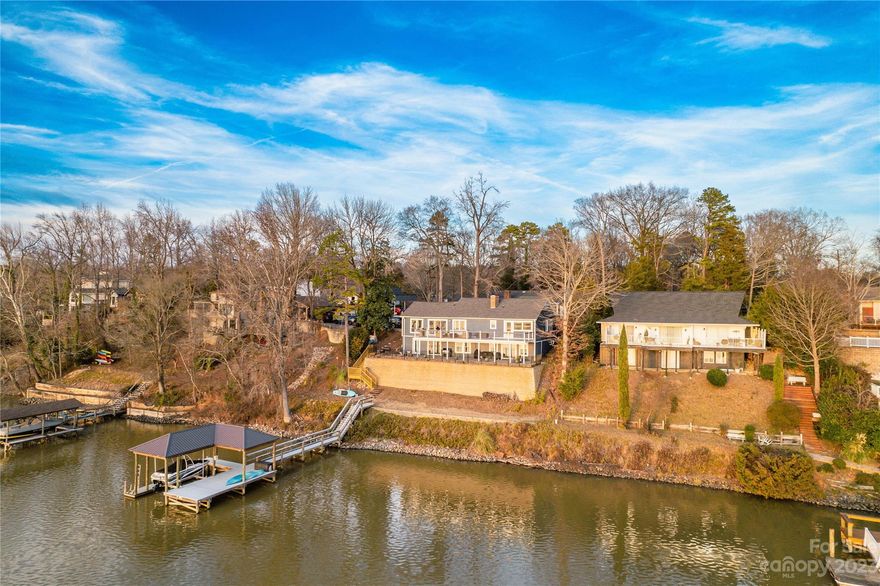 Spectacular Lakefront Views and Captivating Sunsets! Unique 4 bedroom, 3 bath Ranch with finished walk out basement, offering the perfect blend of serene lake living and modern comfort. Nestled on the shores of Lake Wylie, recently renovated and a true gem! The moment you step inside you'll be greeted by the breathtaking panoramic shimmering water views. The open floor plan creates an inviting and spacious atmosphere, perfect for both everyday living and entertaining. Step out to the expansive trex deck which is an ideal spot for enjoying your morning coffee, hosting BBQs, or savoring the sunset views that will leave you in awe. Dock updated with PVC decking and covered boat lift, making boating, fishing, and water sports a breeze. Imagine spending your days on the water creating memories! This lakefront paradise not only offers you the ultimate in relaxation but also the convenience of being close to all that Tega Cay has to offer, including parks, golf courses, and Fort Mill Schools!