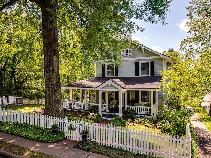 This is "that" house on the corner with the wrap-around porch, on a lot and a half at the "round-about". Walk to restaurants, shops, and the park. Step into the grand room that extends the entire width of the house. High ceilings and wide-cased openings with nice windows. Large family room. Breakfast room goes out to porch. Beautiful floors. Renovated baths and new master bath added by this owner. Den upstairs would make a wonderful master walk-in closet. Back porch. Spacious bedrooms. Lovely!