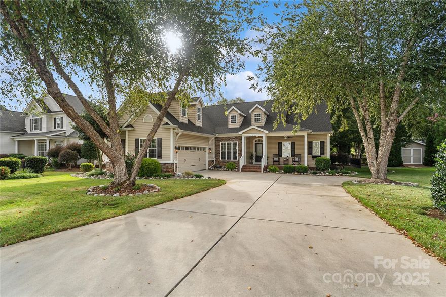 Set on an oversized lot and a half, this exceptional home offers a rare combination of abundant outdoor space and unbeatable convenience. You simply won’t find another property with this much room to spread out—just minutes from I-77, shopping, and dining. From the moment you arrive, this home makes a lasting impression. A charming Southern-style front porch welcomes you before you even step inside. Once indoors, you're greeted by an airy, sun-drenched interior, enhanced by large windows, detailed trim work, and soaring ceilings that create a sense of openness and elegance. The versatile floor plan is designed for modern living, featuring a spacious primary suite and two guest bedrooms on the main level. Upstairs, you'll find a large bonus room with its own full bathroom—perfect for a guest suite, home office, or media room. Step outside to enjoy your private oasis. Savor your morning coffee on the back porch overlooking the lush, landscaped yard, or gather with friends around the cozy fire pit on crisp fall evenings. And there's more—summer days are made for relaxing at the immaculate neighborhood pool, just a short stroll away.