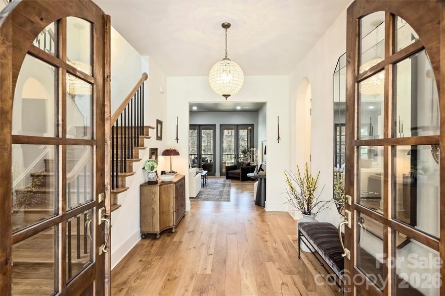 Welcome to 1521 Reflection Pointe Boulevard, a custom-built residence designed by the award-winning team at Vinyet Architecture, located within the gated waterfront community of Reflection Pointe on Lake Wylie. Tucked along a quiet inlet with dockable waterfront access, the home offers a rare combination of privacy, thoughtful design, and beautiful water views framed by expansive windows.
The main level features an open-concept layout centered around a chef’s kitchen with custom cabinetry, oversized island, professional-grade appliances, integrated refrigerator and freezer columns, and a scullery-style pantry with beverage center. The kitchen flows naturally into the dining area and a cozy den with fireplace, while the great room opens directly to the upper deck overlooking the lake, creating an easy connection between indoor and outdoor living.
The main-level primary suite offers a peaceful retreat, entered through a concealed flush-entry door and filled with natural light. The suite enjoys private deck access along with a spa-inspired bath featuring a freestanding soaking tub, walk-in shower, and generous custom closet.
The finished lower level adds flexible living space with a large living room, additional bedroom and bath, private office, dedicated home gym, and bonus space suited for entertaining, guests, or extended living.
Upstairs, a loft provides additional gathering space along with two bedrooms, one with an ensuite bath and the other served by a full hall bath, both positioned to capture lake views.
Outside, the flat backyard stretches gently toward the protected inlet, offering an ideal setting for a future pool, outdoor kitchen, or expanded outdoor living area. With dockable potential, the property presents an exciting opportunity to further enhance the waterfront lifestyle.
Residents of Reflection Pointe enjoy a gated entrance, waterfront clubhouse, resort-style pool, tennis courts, walking trails, and community recreation.
1521 Reflection Pointe Boulevard offers a rare opportunity to enjoy custom architecture, waterfront living, and a vibrant lake community just outside Charlotte.