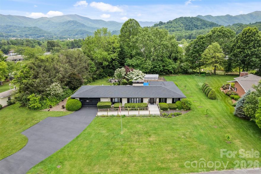 Experience elevated mountain living with the rare combination of in-town convenience and a true, down-to-the-studs renovation in this exceptional Waynesville property. Completely reimagined from 2022–2024, this home offers the peace of mind and quality of essentially new construction with every detail thoughtfully upgraded. 
Set on a level acre with year-round mountain views, the home showcases soaring cathedral ceilings across the living, great room, and kitchen—creating a bright, open, and inviting atmosphere. Two beautifully appointed kitchens feature quartz countertops and modern finishes, complemented by custom-tiled bathrooms and durable luxury vinyl flooring throughout. Designed for both everyday comfort and entertaining, the flexible layout includes 5 bedrooms, a dedicated theater room, game room, second kitchen/wet bar, and additional flex space to suit your needs. Step outside to enjoy a spacious patio, established garden, fruit trees, and a fire pit—perfect for relaxing or hosting under the stars. Major system upgrades add lasting value, including dual-zone HVAC, a 2020 roof, three propane fireplaces, and updated appliances including dryer, range, and water heater. A 2-car garage with additional storage completes the package. Furniture is available, making this a potential turnkey opportunity. All of this just 2–3 miles from downtown Waynesville, with Spectrum high-speed internet and TV available.