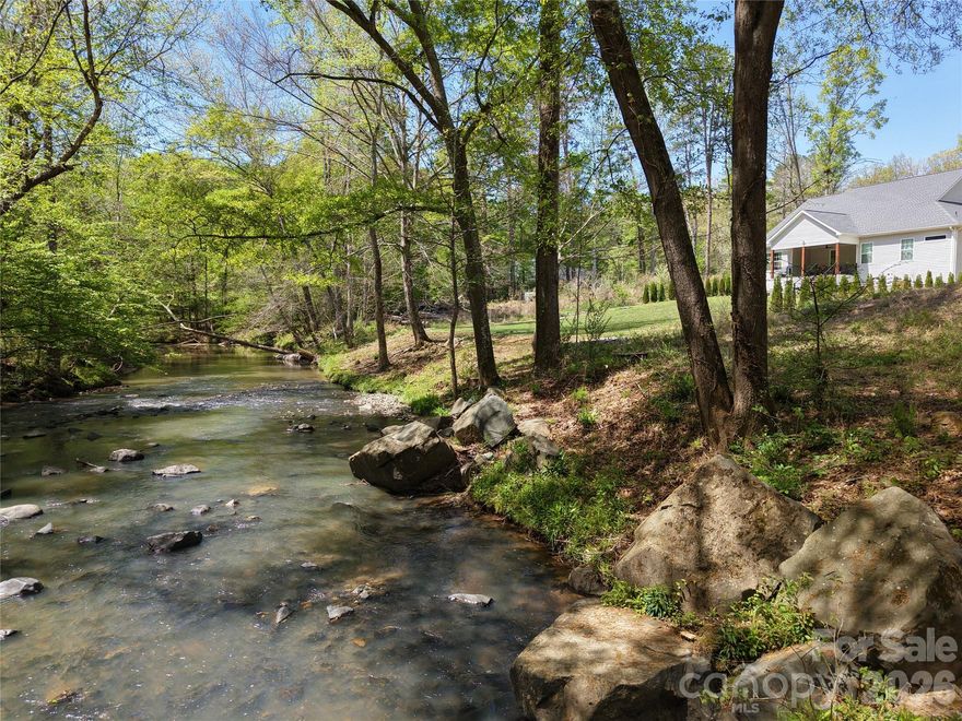 Fantastic creek side lot, very private and convenient to whitewater center, shopping, highways, airport. Lot was recently cleared, ready to build, city sewer tap fee required, well needed. This peaceful property offers the perfect mixture of nature and convenience, with easy access to outdoor adventures, hiking, biking, and kayaking. Ideal for a private retreat or custom home, this lot provides a stunning natural backdrop. No HOA – bring your vision and make it your own!